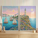 A pair of vertical rectangular artworks is displayed side-by-side on a light-colored wooden surface. Both pieces feature a textured, mosaic-like style composed of numerous small dots of color to create a serene coastal theme.

The artwork on the left depicts a calm turquoise bay with three small sailboats. Each boat features unique, intricate patterns on its sails in shades of pink, orange, and blue. In the background, a cluster of pastel-colored houses sits nestled on a green hillside. 