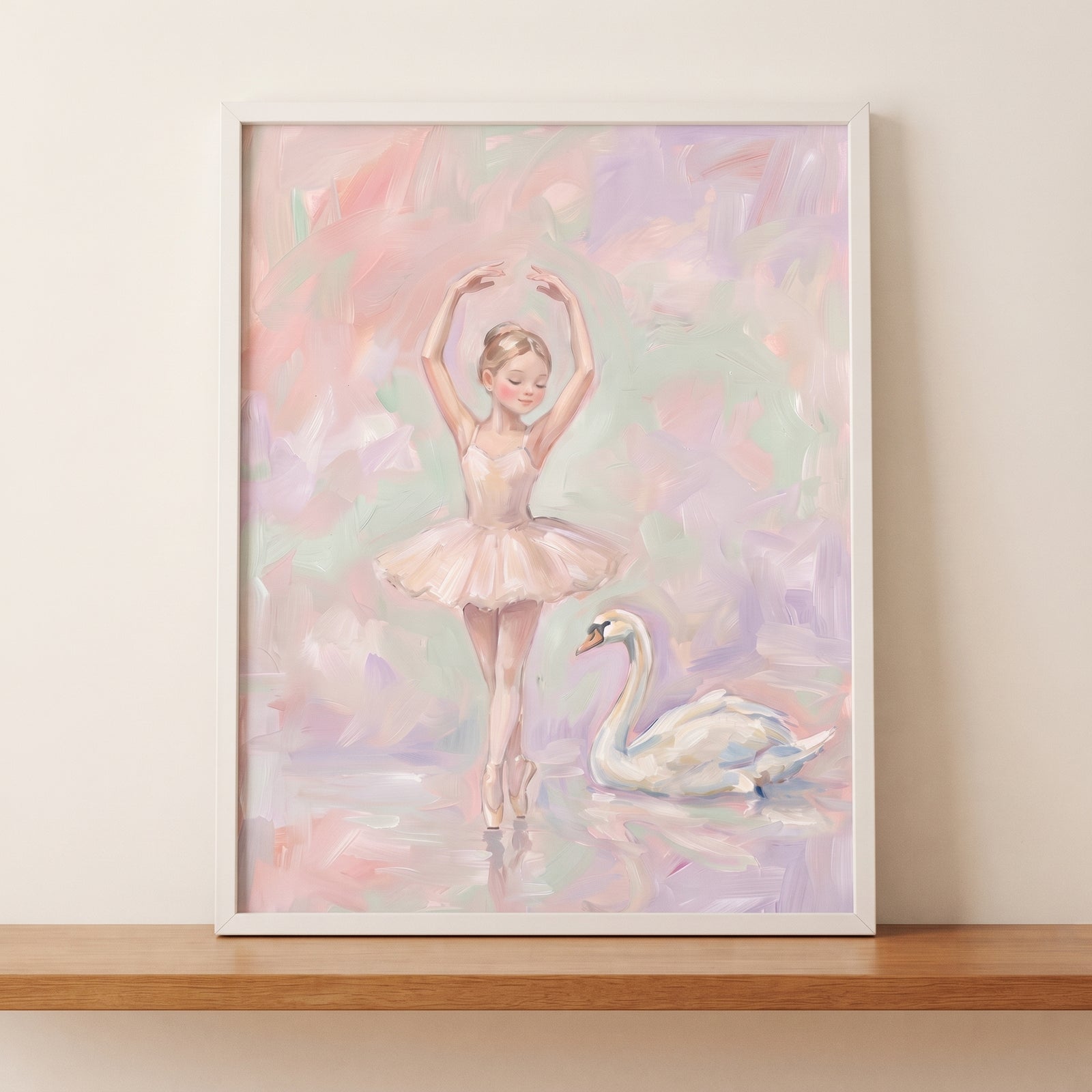 Pastel pink ballerina wall art featuring a dancer and swan in soft colors, framed on a wooden shelf.