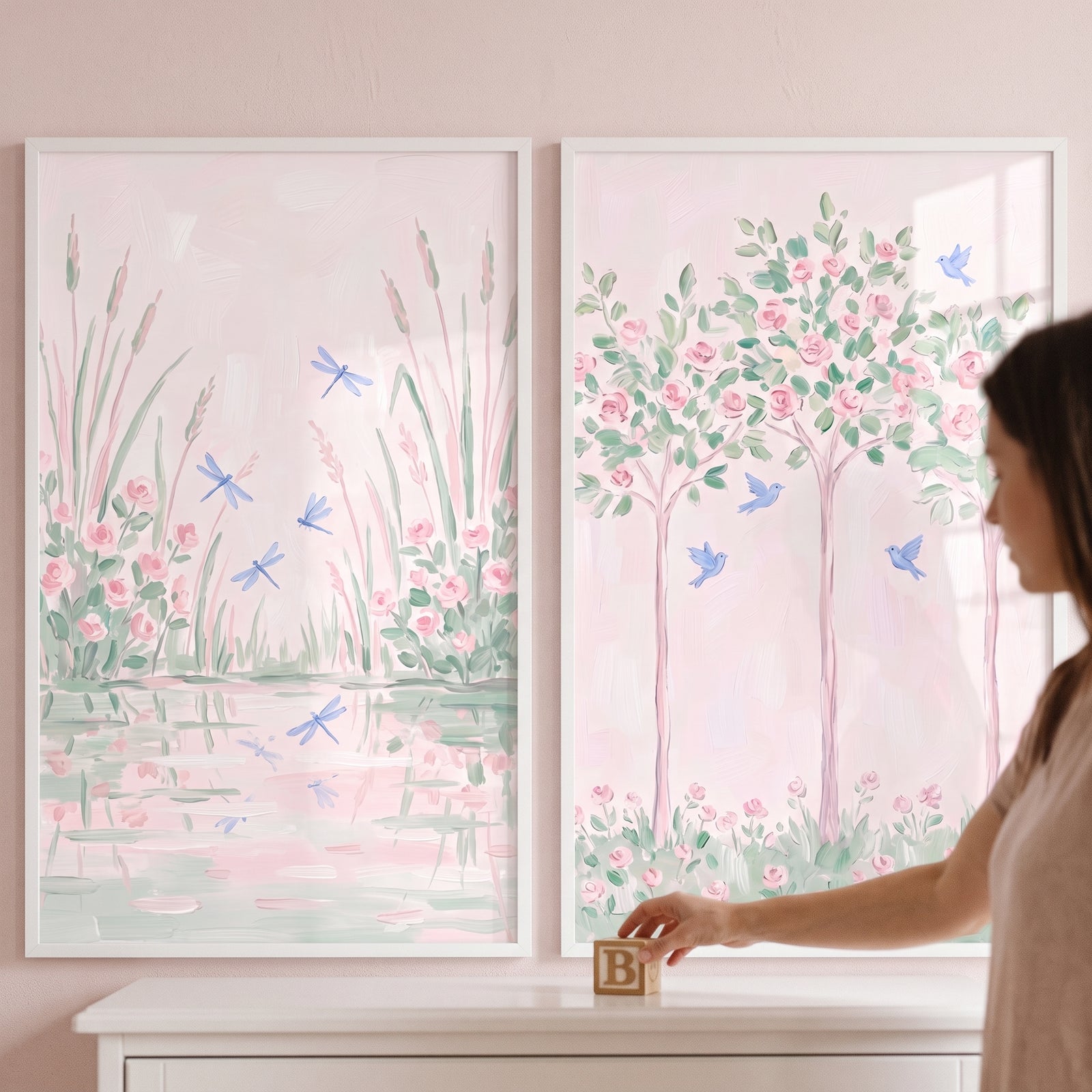Pastel pink rose garden wall art set of 2 with flowers, birds and dragonflies above a dresser as a hand places a wood block.