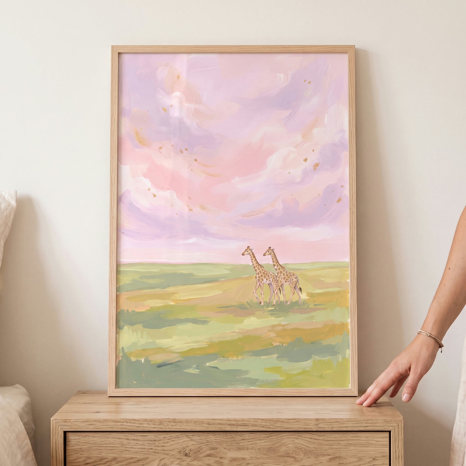 Framed pastel pink sunset giraffes animal wall art shows two giraffes in a field under a soft pink and purple sky.
