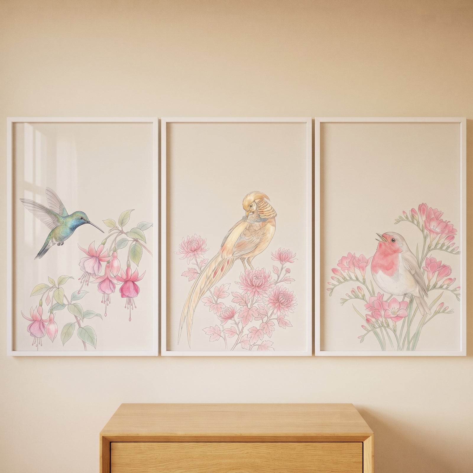 Pastel pink watercolor birds wall art set of 3 depicting a hummingbird, pheasant, and robin above a wood dresser.