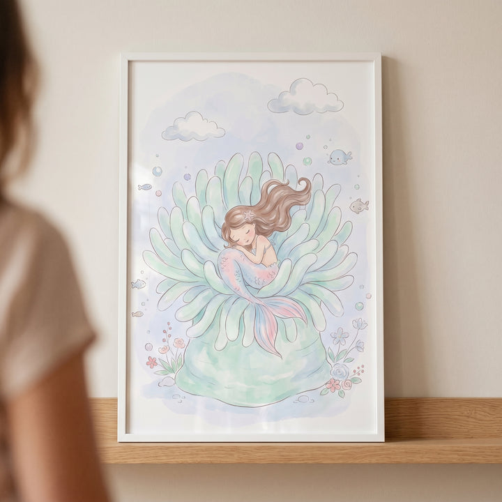 Pastel sea anemone mermaid wall art featuring a sleeping mermaid with brown hair and a pink tail in a soft green anemone.