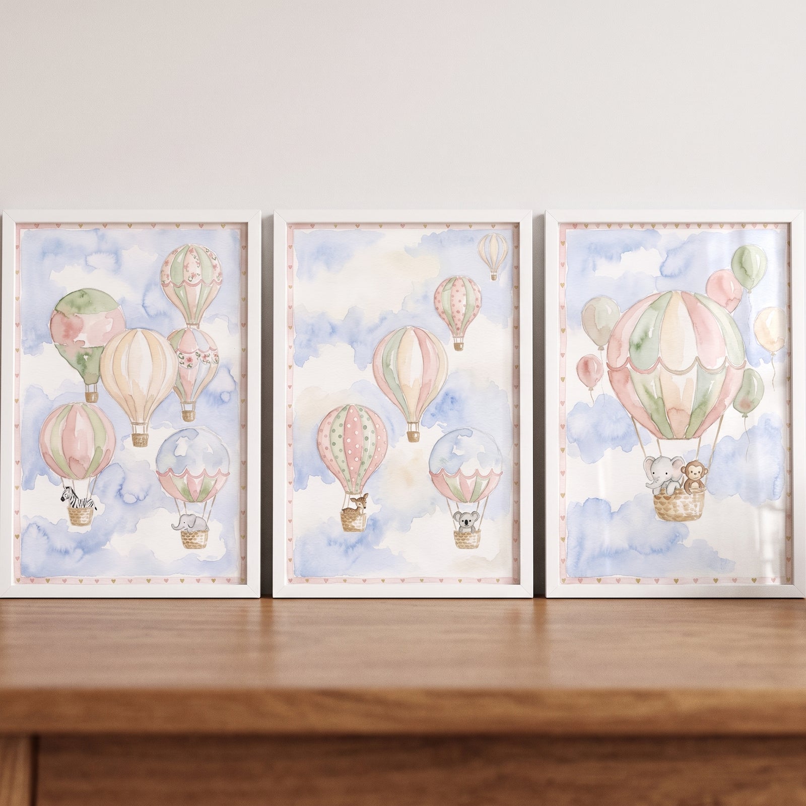 Watercolor hot air balloons and animals float through clouds in this pastel sky balloon animal wall art set of 3.