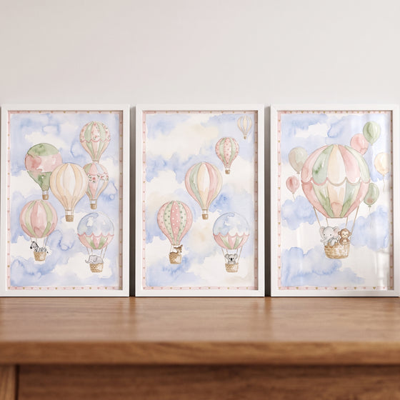 Watercolor hot air balloons and animals float through clouds in this pastel sky balloon animal wall art set of 3.