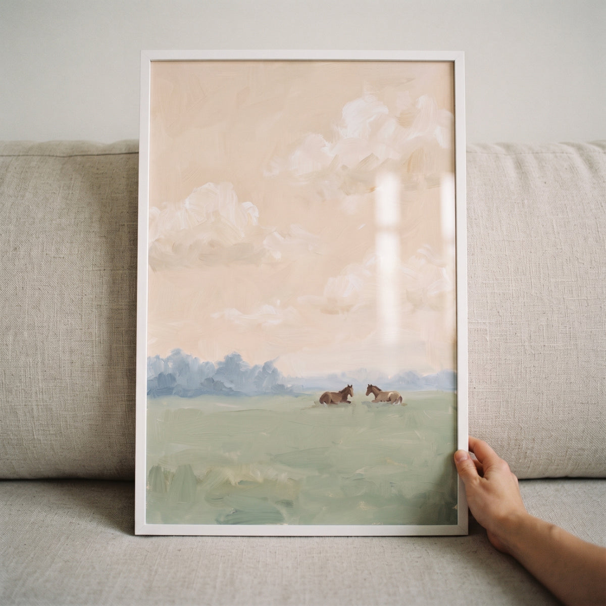 Framed pastel sky resting horse print shows two brown horses in a green field under a soft peach sky with white clouds.