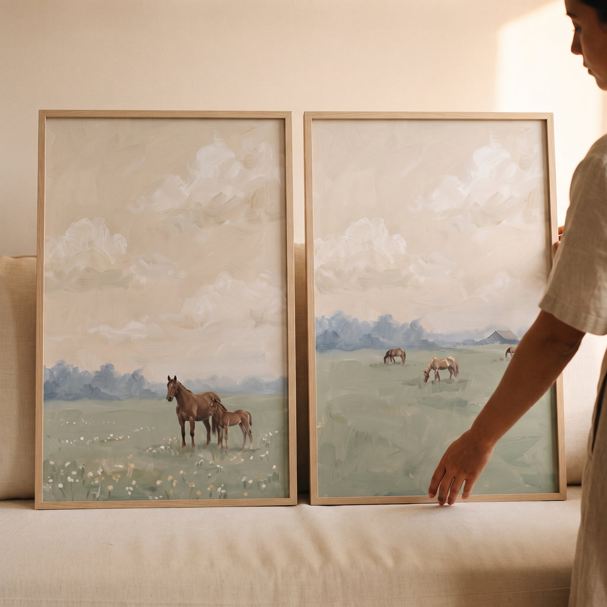 Peaceful sage meadow horse wall art set of 2 featuring horses grazing in soft green fields under a cloudy cream sky.
