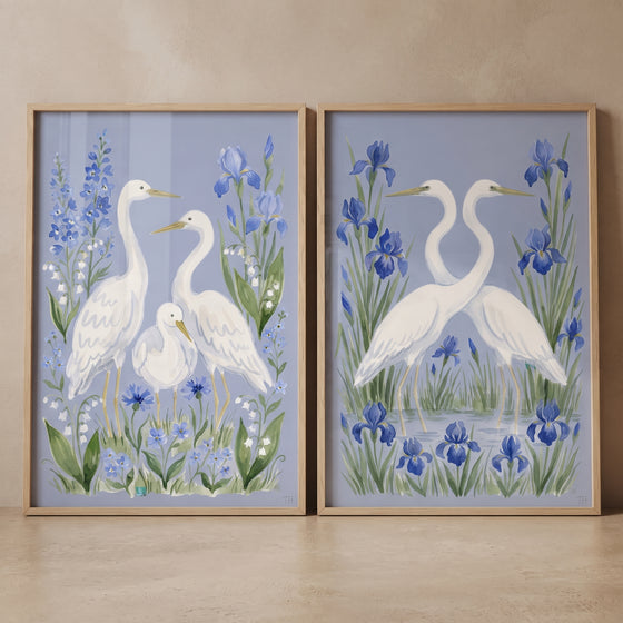 Periwinkle garden white egret bird wall art set of 2 with white egrets and blue irises in light wood frames.
