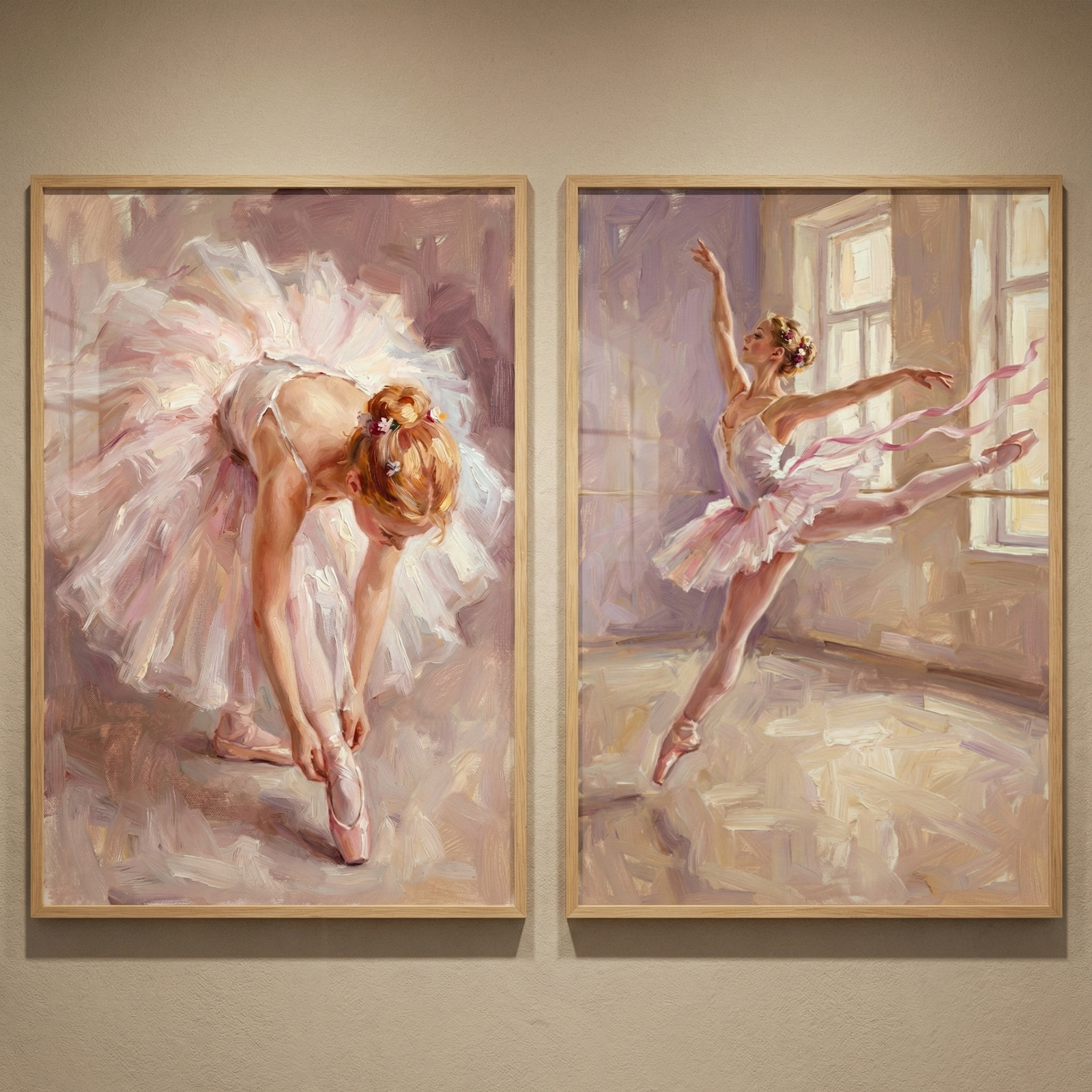 Two framed artworks are displayed side-by-side on a neutral wall. The left piece features a ballerina with a floral bun, leaning down to adjust her pink pointe shoes. She wears a large, multilayered tutu in soft pink and white tones. The right piece shows a ballerina in a dynamic dance pose, leaping in a sunlit room with large windows. Long pink ribbons flow gracefully around her. 