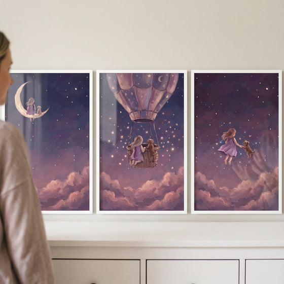 Pink clouds girl dog wall art set of 3 showing a girl and dog on a moon, in a hot air balloon, and among the stars.