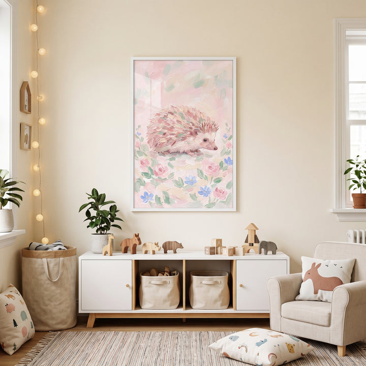 Pink floral garden hedgehog wall art hangs in a neutral nursery with wooden toys, storage bins, and a small armchair.