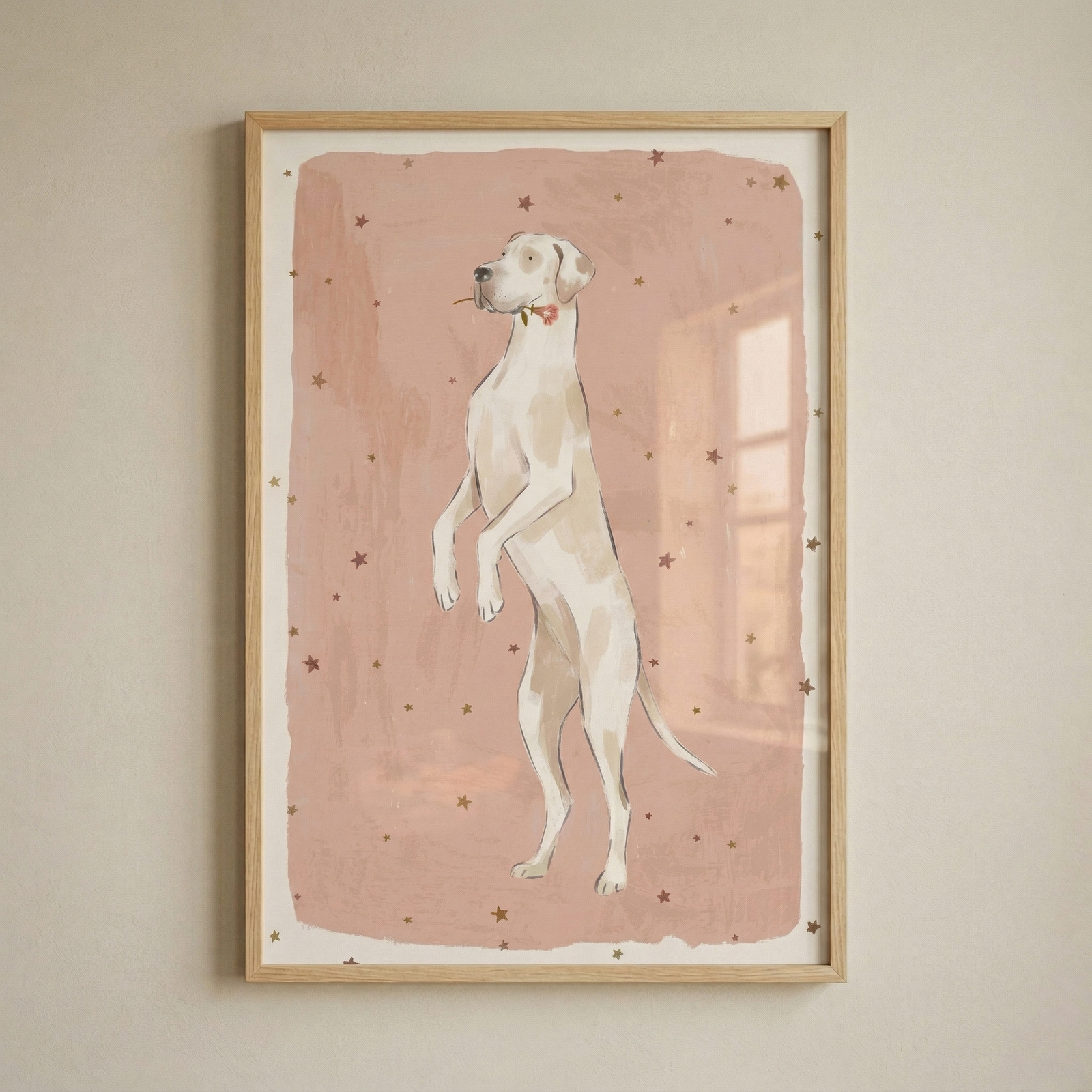 A minimalist illustration of a tall, slender dog with light tan patches standing on its hind legs. The dog holds a small red flower in its mouth and gazes off to the side. Behind the animal is a large, rectangular block of muted pink color with irregular, hand-drawn edges, all set against a cream-colored background. Small, brown five-pointed stars are scattered throughout the pink area. The artwork is presented within a simple, light wood frame hanging on a textured, neutral-toned wall. 