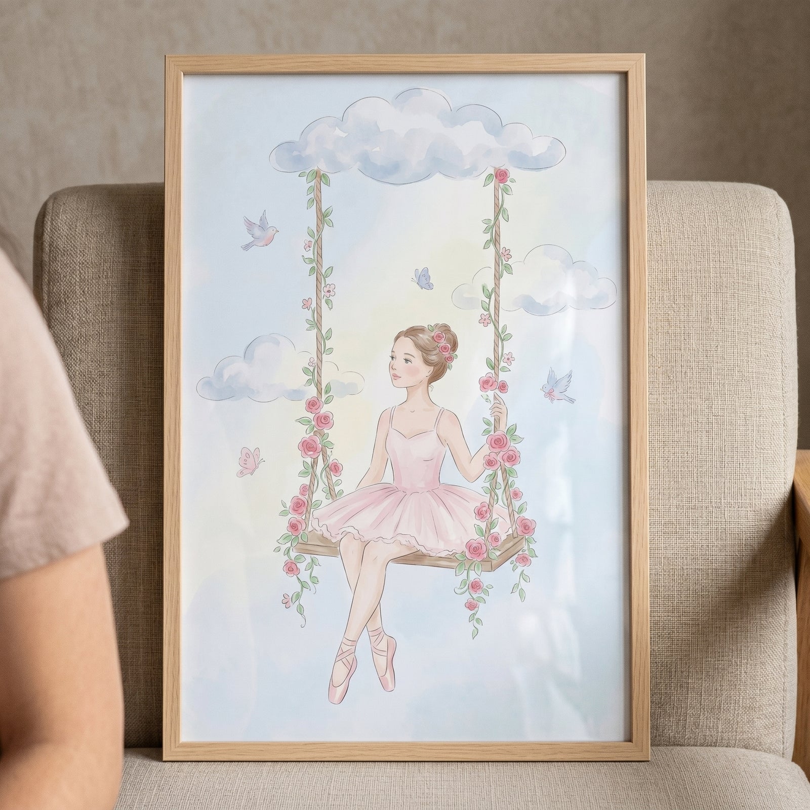 Framed pink rose swing ballerina wall art shows a dancer on a floral swing among clouds, birds, and butterflies.