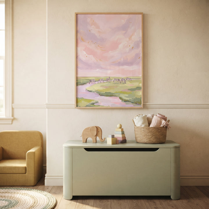 Pink sky grazing zebra animal wall art hangs above a green toy chest in a nursery with a yellow chair and wooden toys.