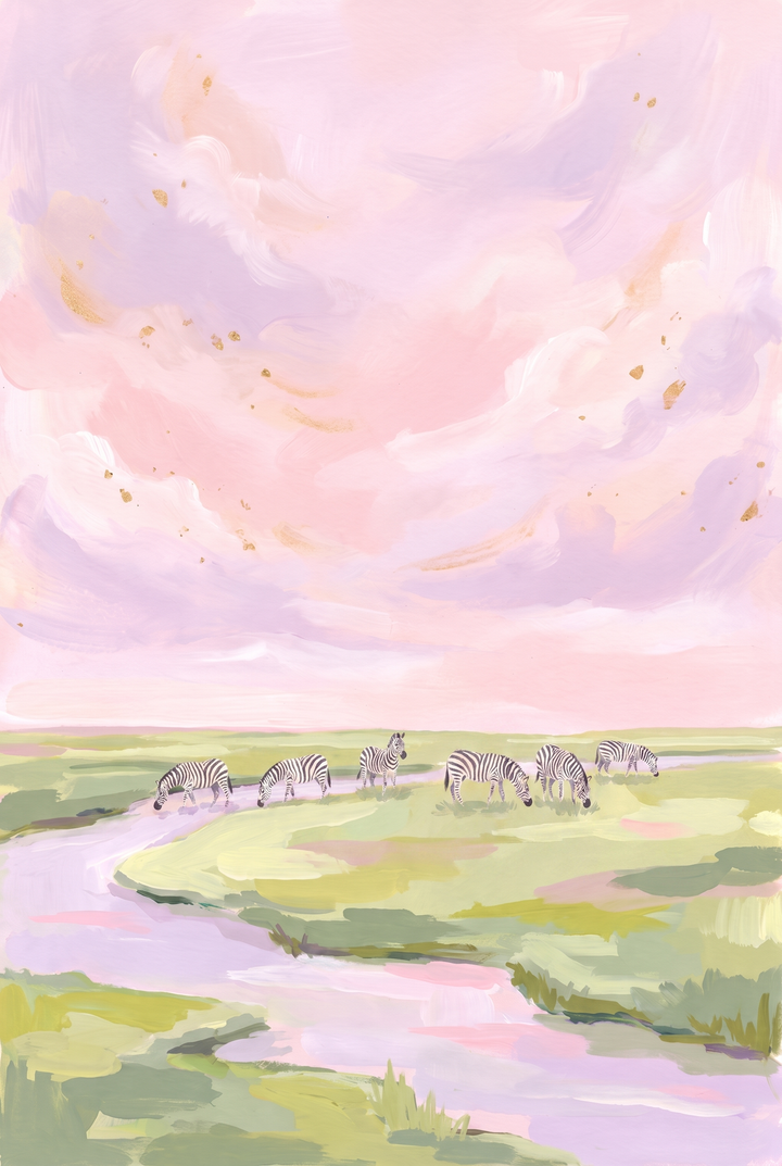 Zebras graze by a river under a pink sky grazing zebra animal wall art with purple clouds and gold accents.