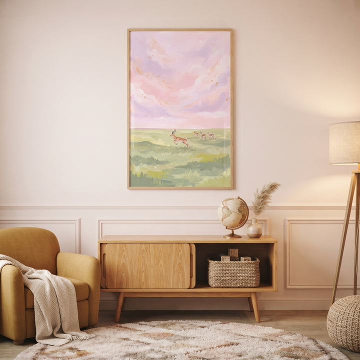 Pink sky leaping gazelle animal wall art hangs above a wooden sideboard and yellow chair in a warm interior.