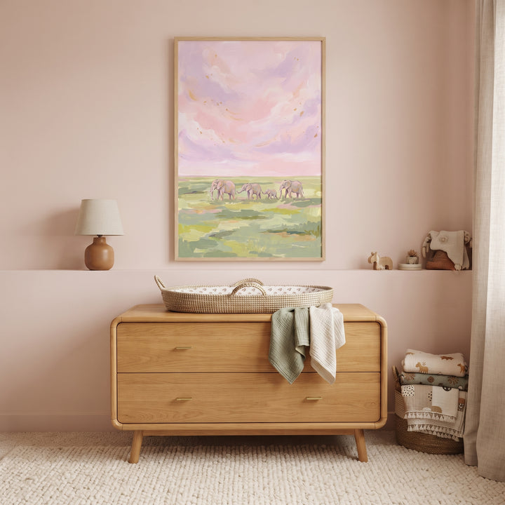 Pink sky walking elephants animal wall art hangs above a wooden dresser, woven changing basket, and small lamp.