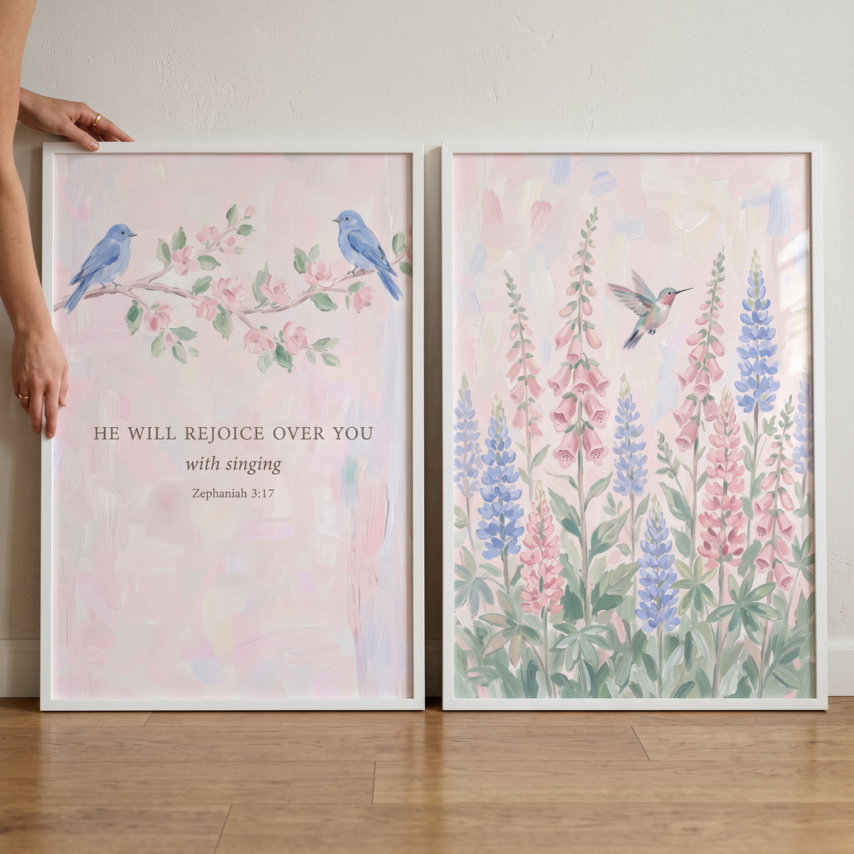 Pink spring garden birds wall art set of 2 features bluebirds, a hummingbird, lupines, and a Bible verse in white frames.