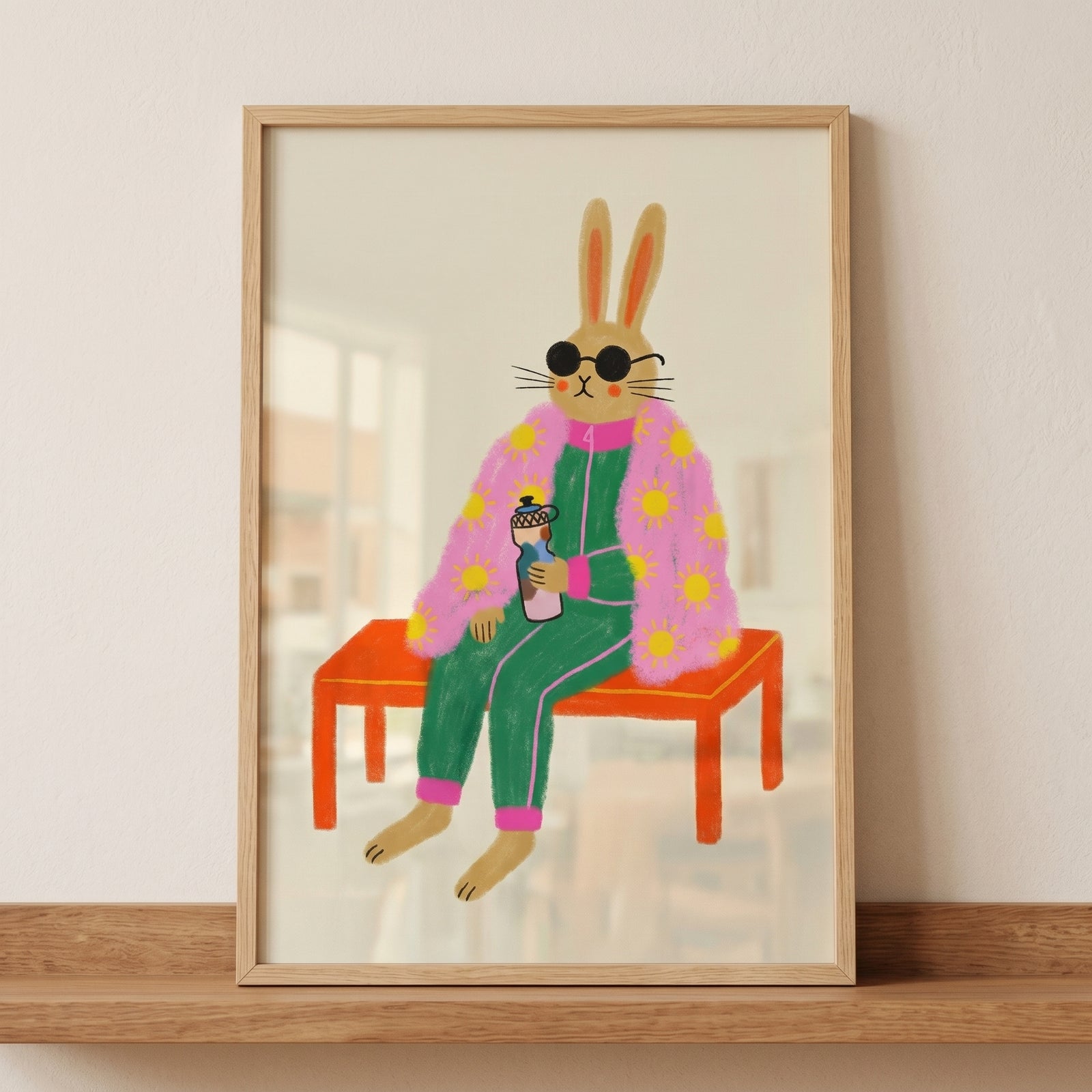 Pink sun robe rabbit wall art shows a rabbit in sunglasses and a green tracksuit sitting on an orange bench.
