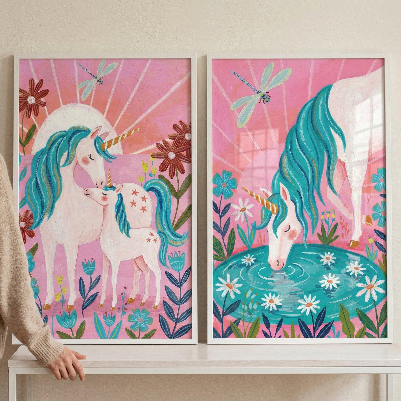 Pink sunburst teal unicorn wall art set of 2 showing unicorns with flowers and dragonflies in white frames.