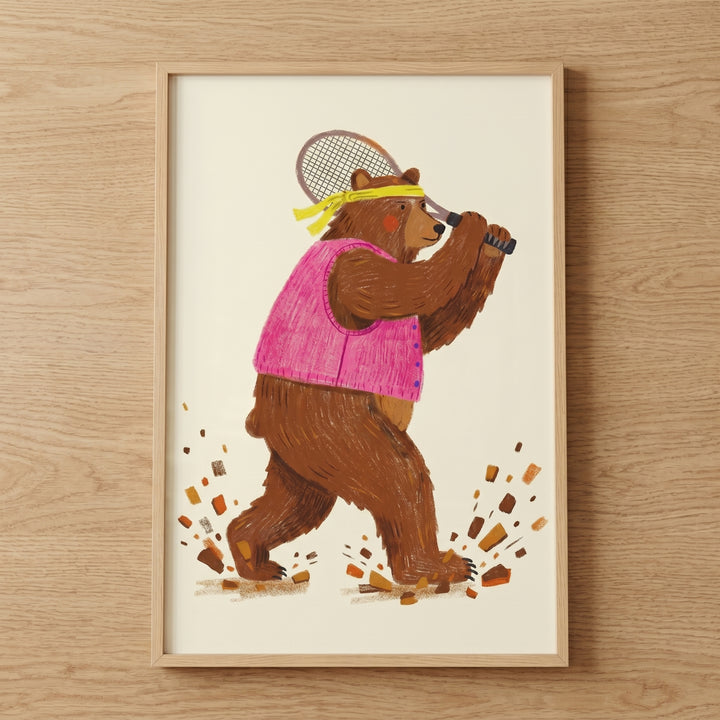 Pink vest tennis bear wall art features a brown bear with a yellow headband swinging a racket as dirt kicks up.