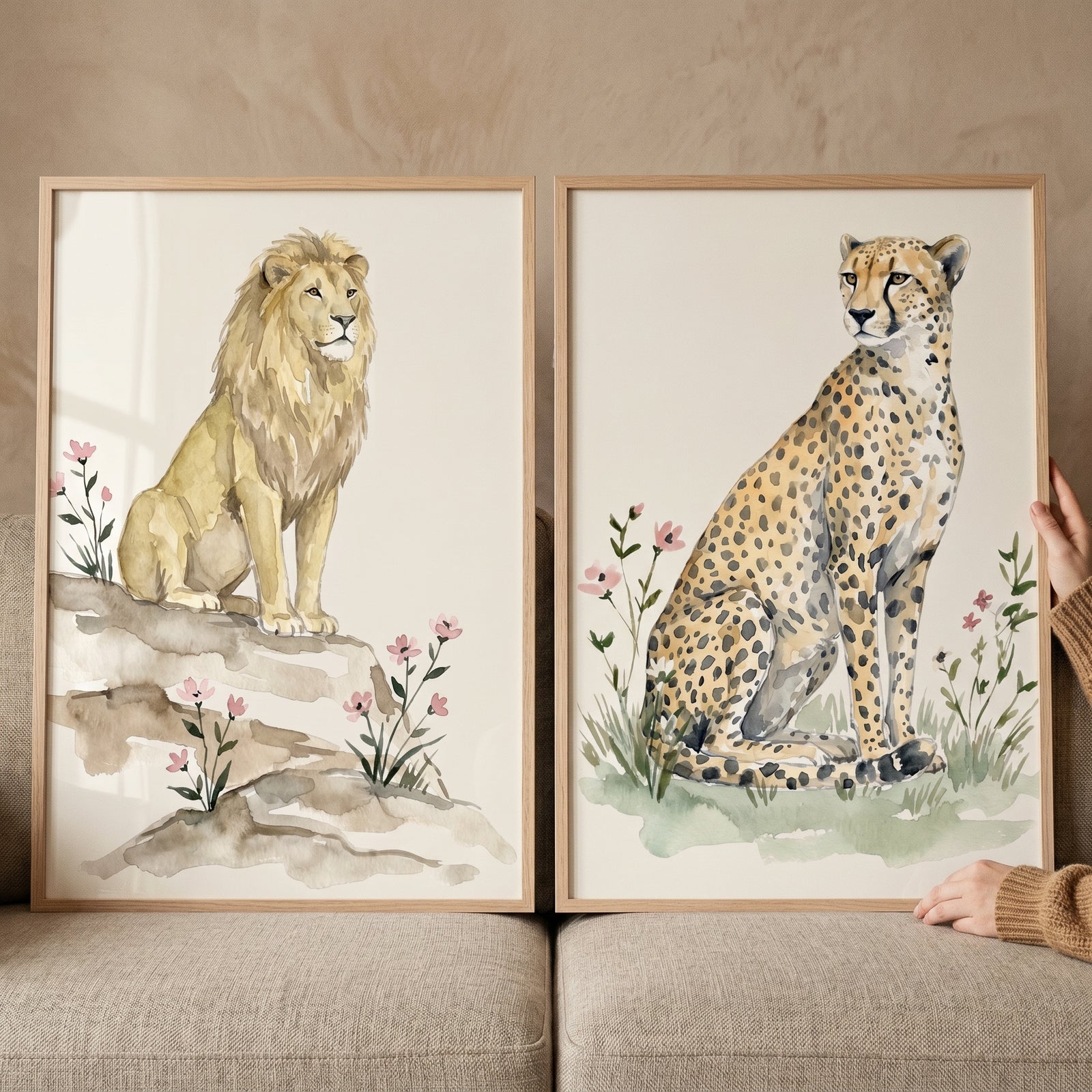 Watercolor lion and cheetah pink wildflower safari animal wall art set of 2 in light wood frames.