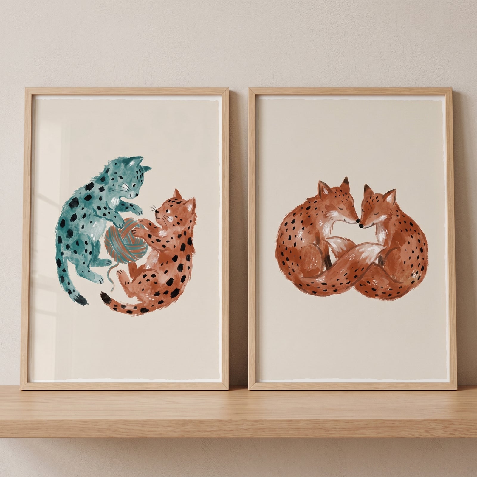Playful black dot animal wall art set of 2 includes framed cats with yarn and foxes curled in a heart shape.