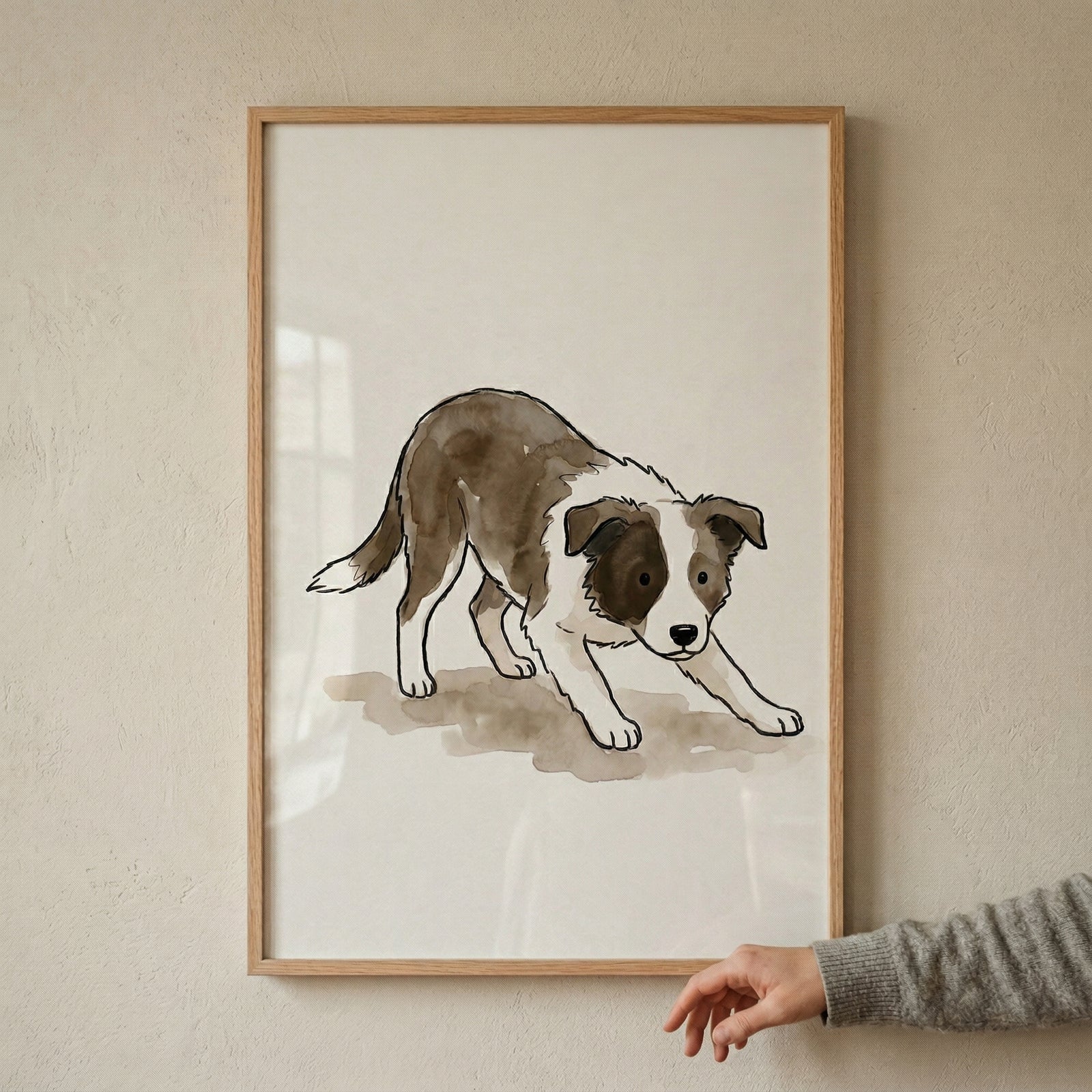 A minimalist watercolor and ink illustration of a brown and white herding dog puppy. The puppy is in a playful crouching pose, with its front legs stretched forward and its head held low in an energetic play-bow. The style features soft, translucent washes of brown and grey watercolor with fine black ink lines for detail. 