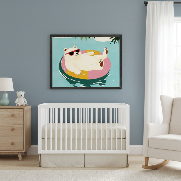 Modern nursery with a white crib, wooden dresser, and white rocking chair. A large framed print of a cartoon polar bear wearing red sunglasses on a colorful floatie in water hangs above the crib.