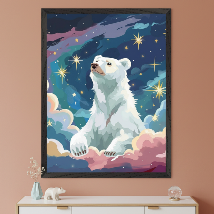 Illustrated wall art of a dreamy polar bear sitting on pink and peach-toned clouds, surrounded by golden stars and a vibrant night sky with auroras. The framed artwork hangs on a terracotta-colored wall above a white cabinet with a small polar bear figurine and minimalist decor.