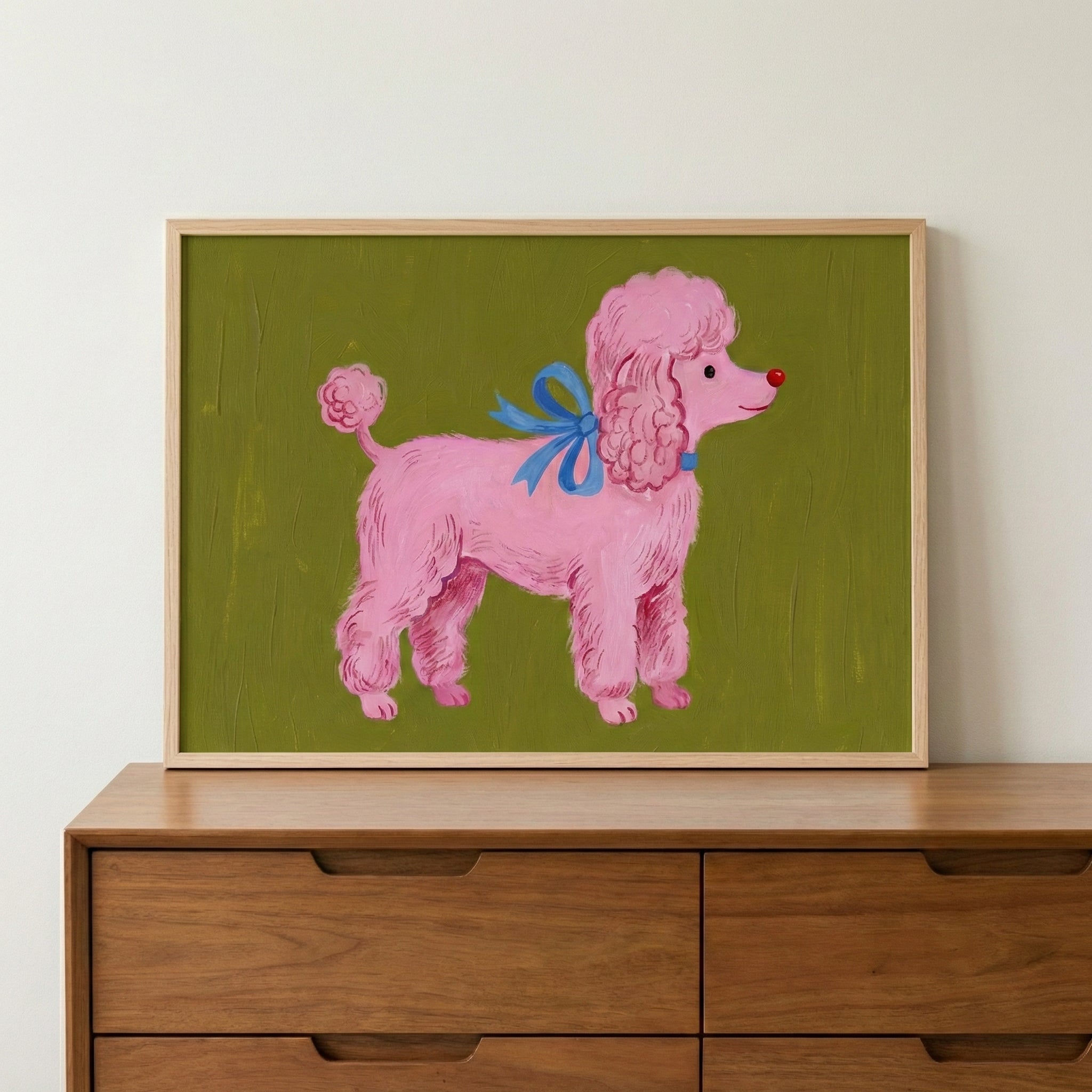 A playful painting of a fluffy pink poodle with a bright red nose and a blue ribbon tied around its neck, standing confidently against a mossy green background. The bold colors and whimsical details give it a lighthearted, storybook vibe.