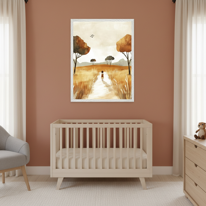 Modern nursery with a light wood crib and gray armchair. A framed print of a child walking on a path through a golden field with trees under a pale sky hangs centered above the crib.