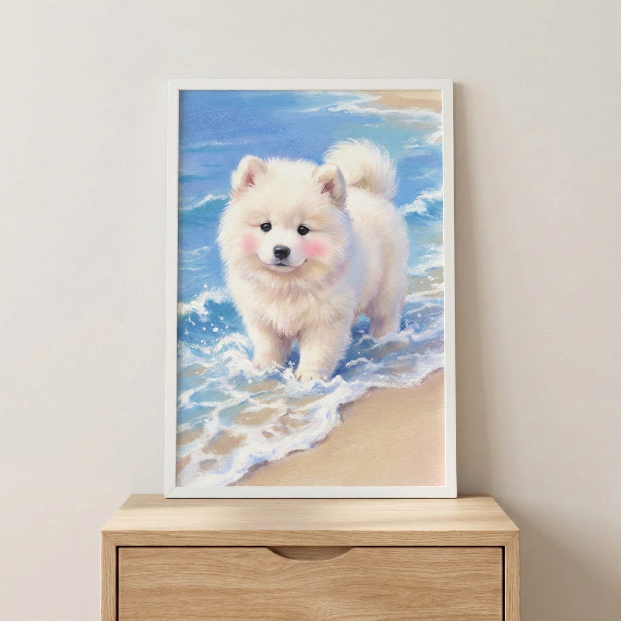 A vertical artwork depicting a fluffy white puppy with soft pink cheeks and dark eyes. The dog stands in shallow, white-capped blue ocean water on a sandy beach. The scene is presented in a simple white frame resting on a light-colored wooden dresser against a neutral wall. The illustration has a soft, whimsical style with vibrant blues and sandy tones, creating a peaceful and cute aesthetic for interior decor.