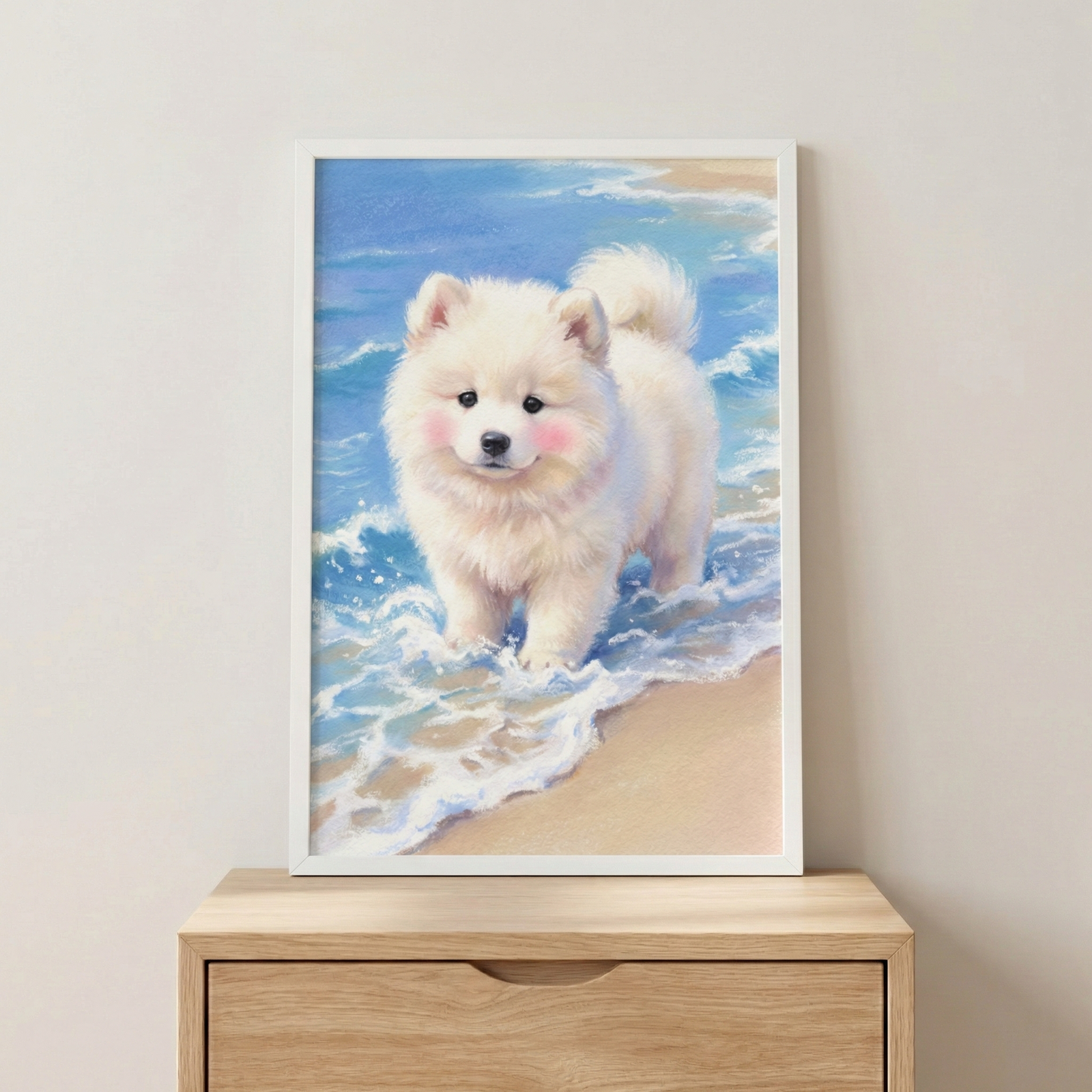 A vertical artwork depicting a fluffy white puppy with soft pink cheeks and dark eyes. The dog stands in shallow, white-capped blue ocean water on a sandy beach. The scene is presented in a simple white frame resting on a light-colored wooden dresser against a neutral wall. The illustration has a soft, whimsical style with vibrant blues and sandy tones, creating a peaceful and cute aesthetic for interior decor.