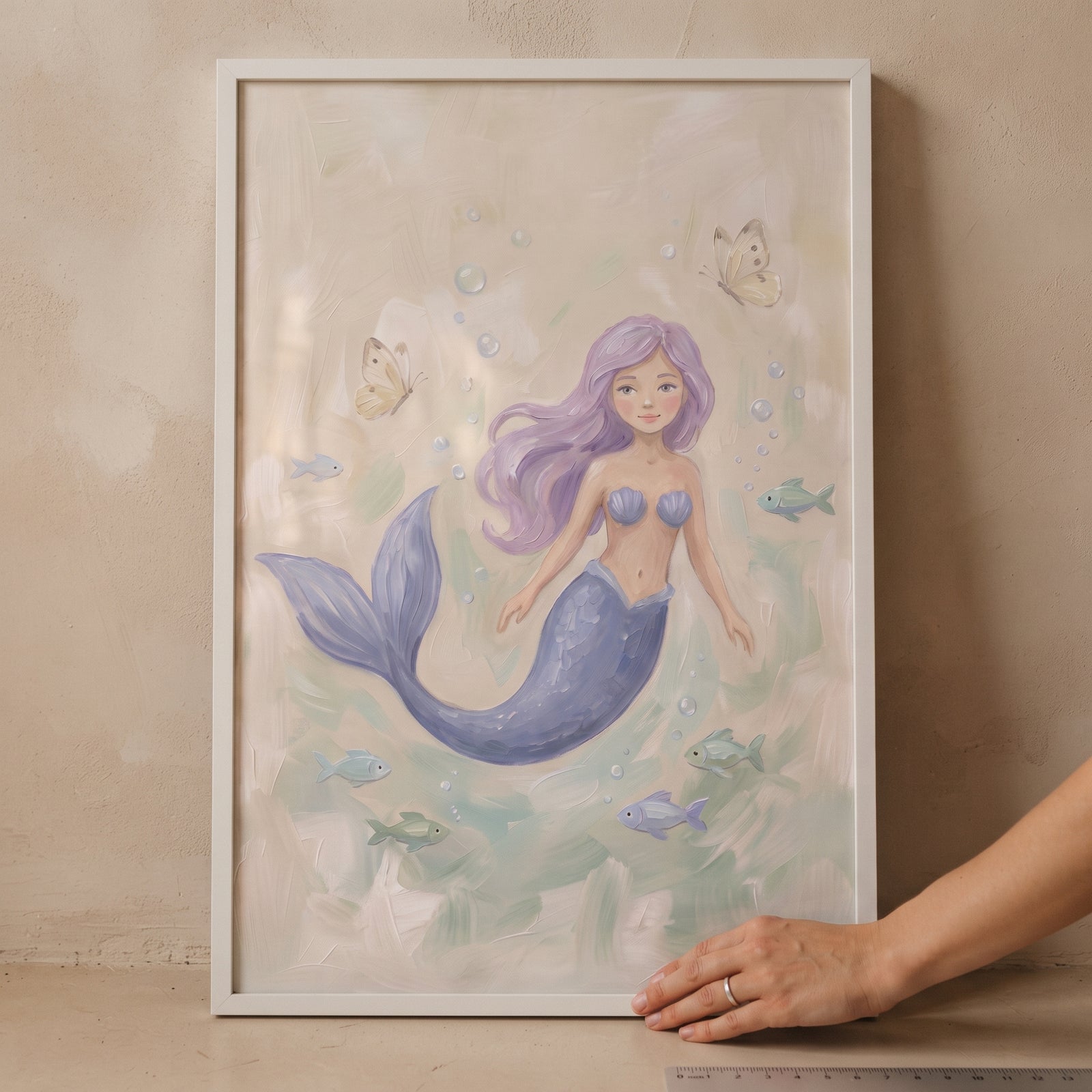 Framed purple hair mermaid wall art with a blue tail, fish, and butterflies in a muted pastel underwater scene.