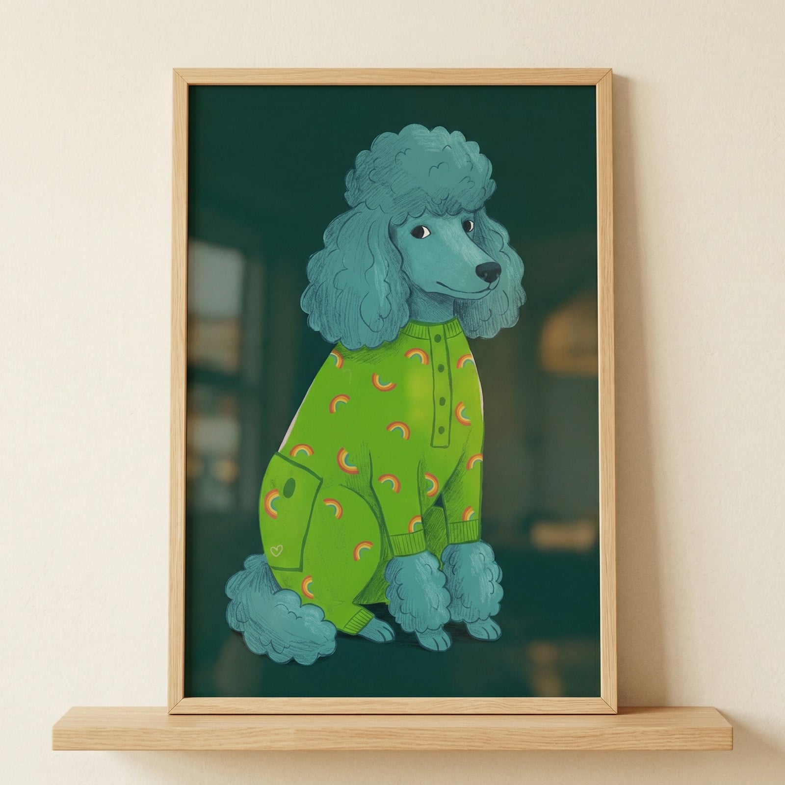 A vertical framed illustration features a stylized, teal-colored poodle sitting calmly. The dog is wearing a bright lime green onesie decorated with a pattern of small orange and yellow rainbows. The onesie has a visible button placket down the front and a small side pocket with a tiny white heart on it. 
