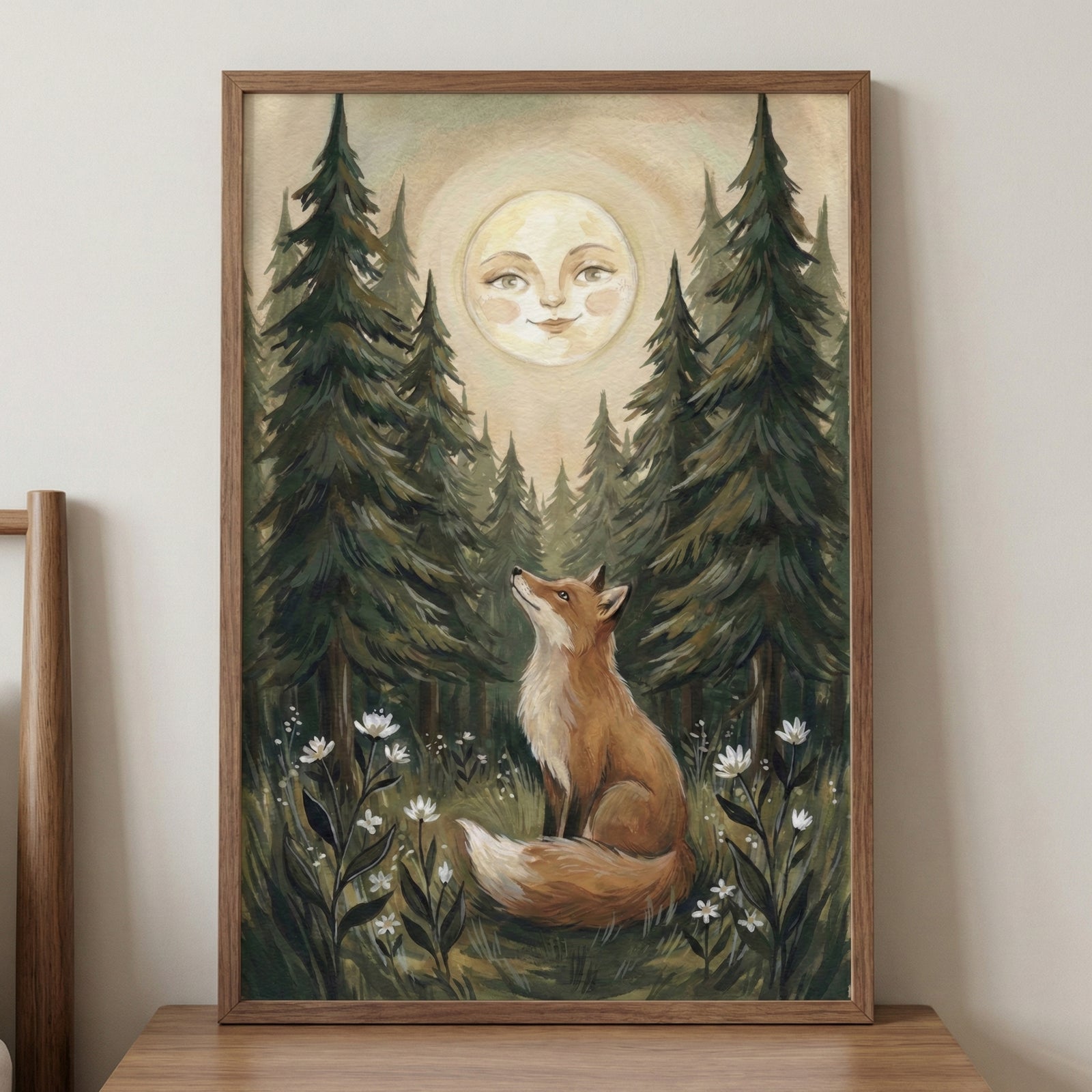 A vertical illustration of a red fox with a fluffy, white-tipped tail sitting in a forest clearing and gazing upwards. Above the fox, a large full moon with a gentle, smiling human face sits between tall, dark green pine trees. Small white wildflowers are scattered across the forest floor in the foreground. The image has a whimsical folk-art style with muted earthy tones and visible textured details.