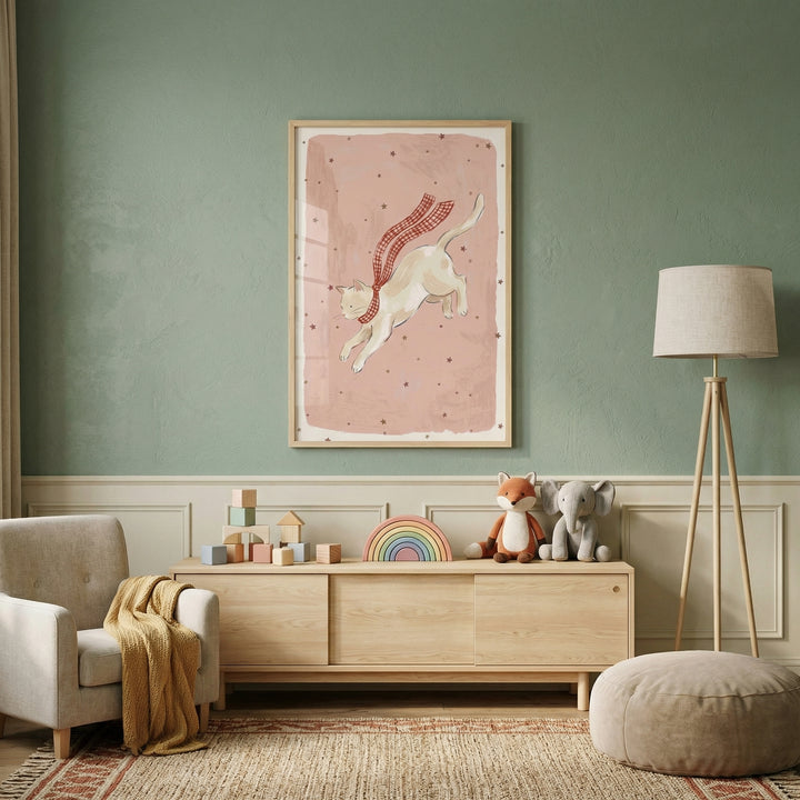 Cozy children’s room with a wooden toy console styled beneath a framed illustration of a cat mid leap wearing a flowing red checkered scarf on a soft pink background with scattered stars. Plush toys, pastel blocks, a rainbow stacker, and warm neutral textures create a playful and inviting space.