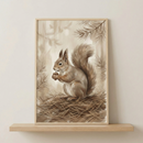 A framed illustration of a brown squirrel holding an acorn. The squirrel features soft fur and a large, bushy tail, sitting atop a nest of pine needles. The background is filled with delicate pine branches and muted, earthy washes of color. This artwork is presented in a light wood frame and is resting on a simple wooden shelf against a neutral wall. The entire scene has a warm and rustic aesthetic.