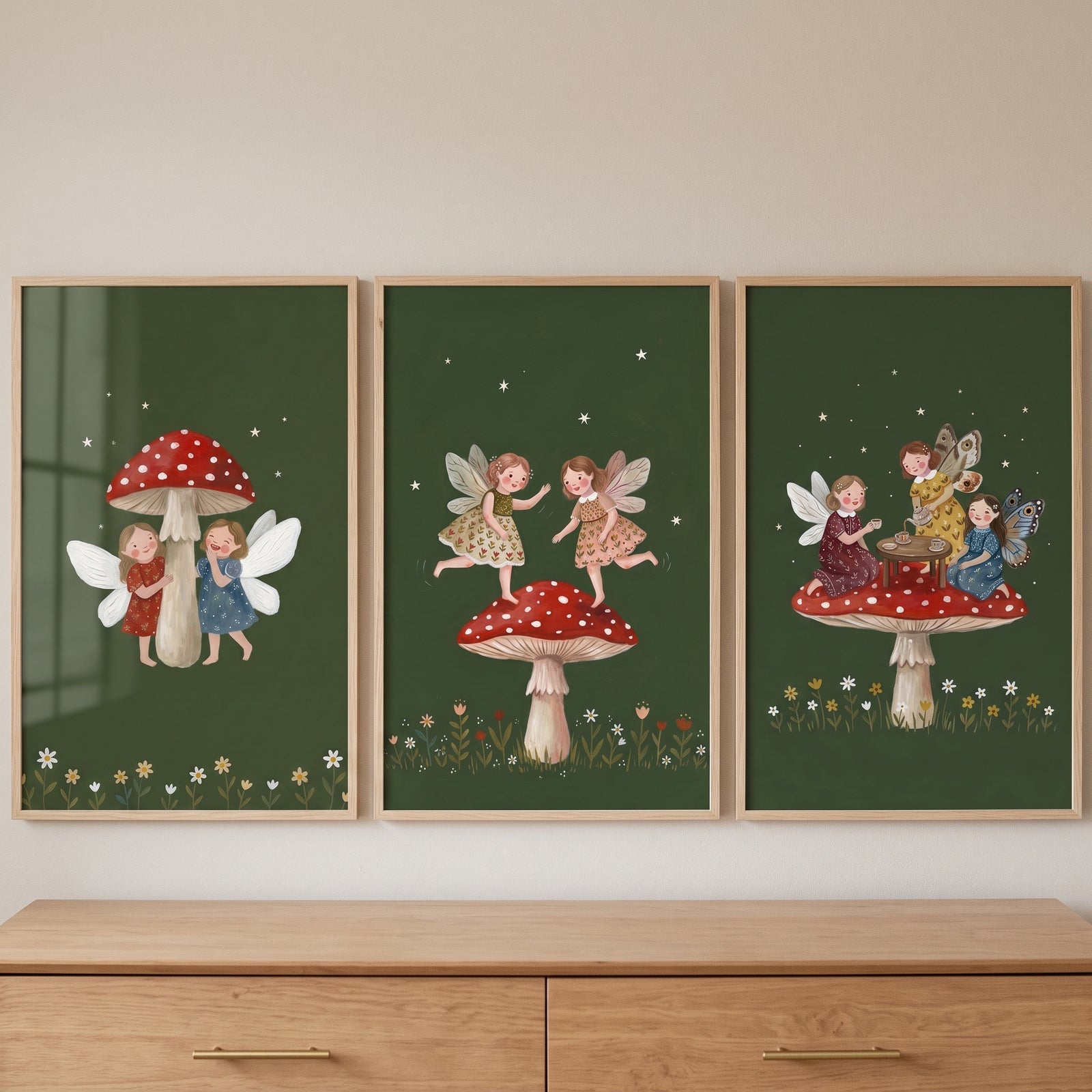 Red toadstool forest fairies wall art set of 3 illustrations feature whimsical winged figures on a green background.