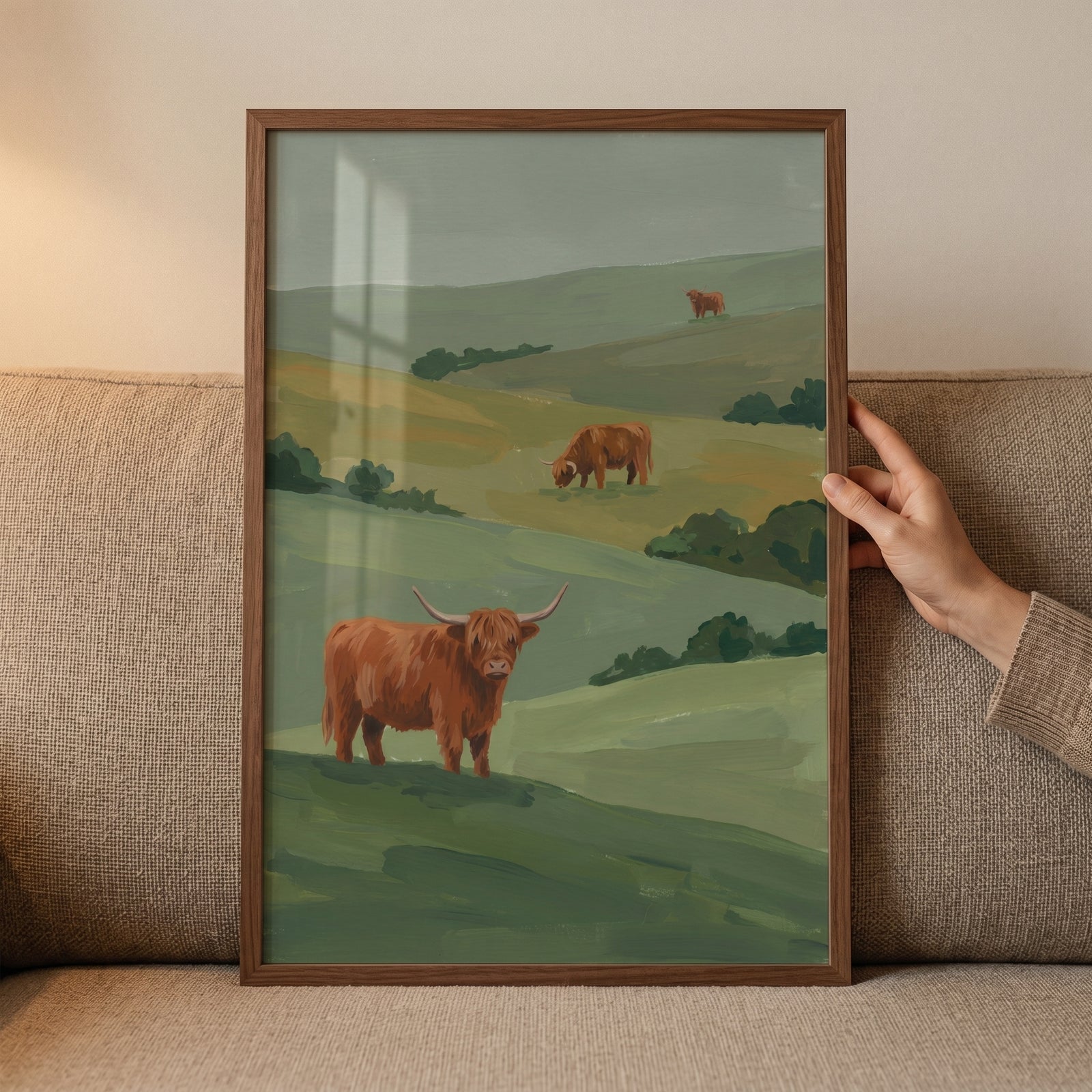Framed rolling hill highland cow wall art showing three cattle grazing on misty green hills.