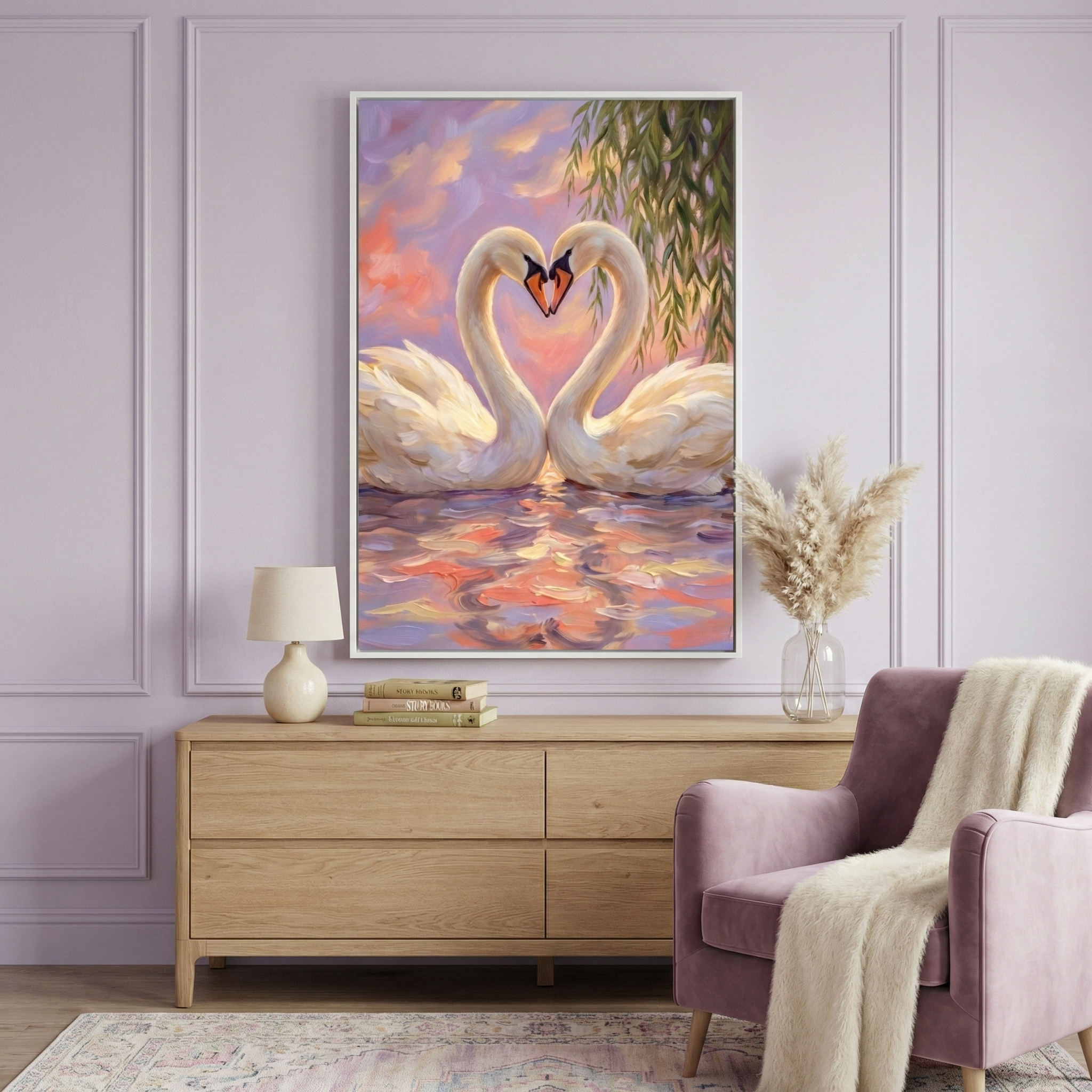 A cozy living room features a large painting of two swans forming a heart shape with their necks against a vibrant sunset backdrop. The room includes a light wood dresser with a lamp and stacked books, a vase with pampas grass, and a plush mauve armchair draped with a soft cream throw.