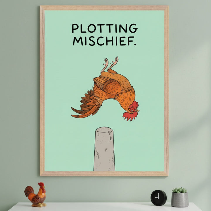 Modern room with light green walls and a white shelf. A large framed print of an upside-down cartoon rooster above a grey post, with 'PLOTTING MISCHIEF' text, hangs above the shelf. A rooster figurine, black clock, and succulent are on the shelf.