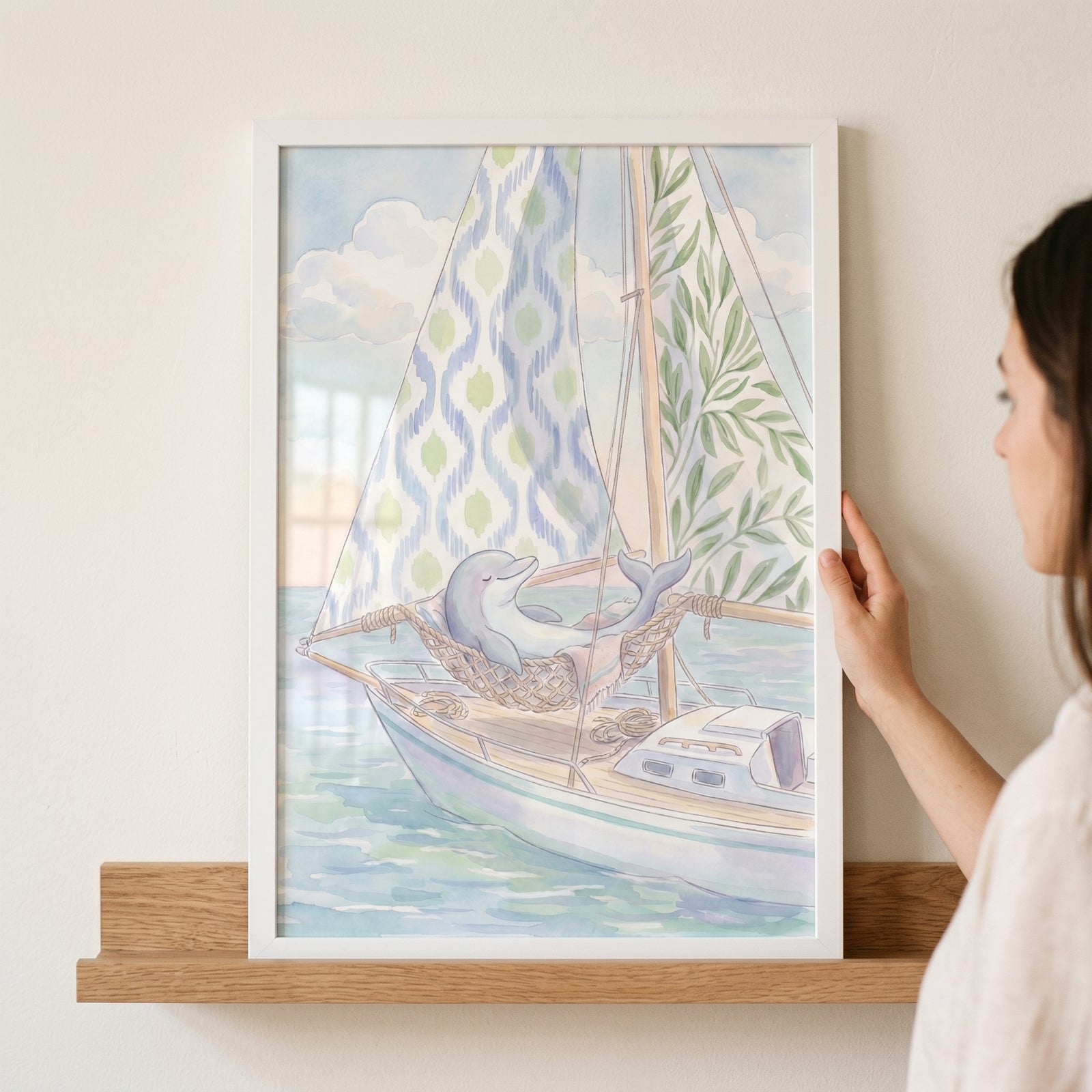 Framed rope hammock napping dolphin wall art on a sailboat with ikat and leaf patterned sails in watercolor style.