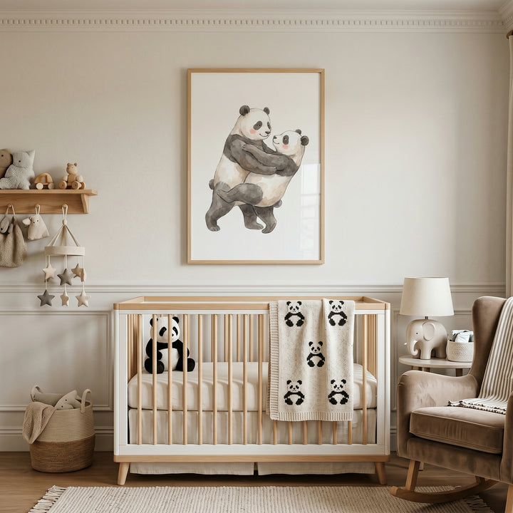 Neutral nursery featuring rosy cheek dancing panda artwork above a crib with a panda blanket and stuffed animal.