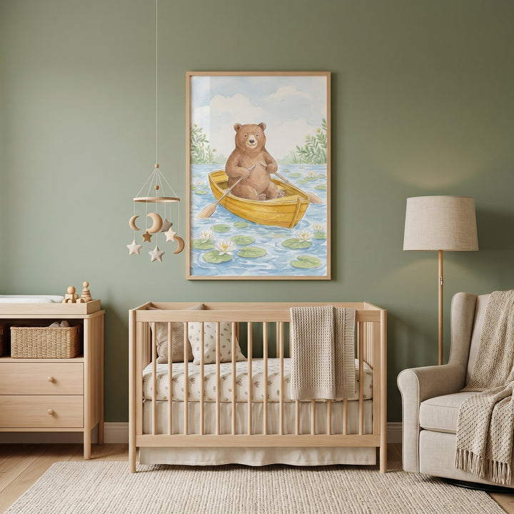 Rowing yellow boat bear wall art hangs above a wooden crib in a green nursery with a beige armchair and lamp.