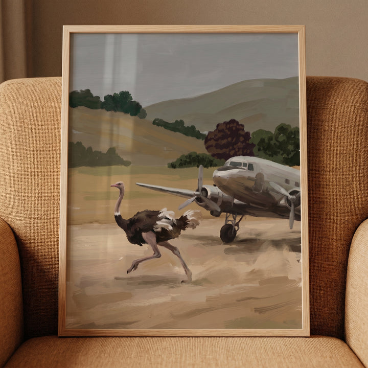 An ostrich sprints past a vintage propeller plane on a dirt runway in this running desert ostrich wall art.
