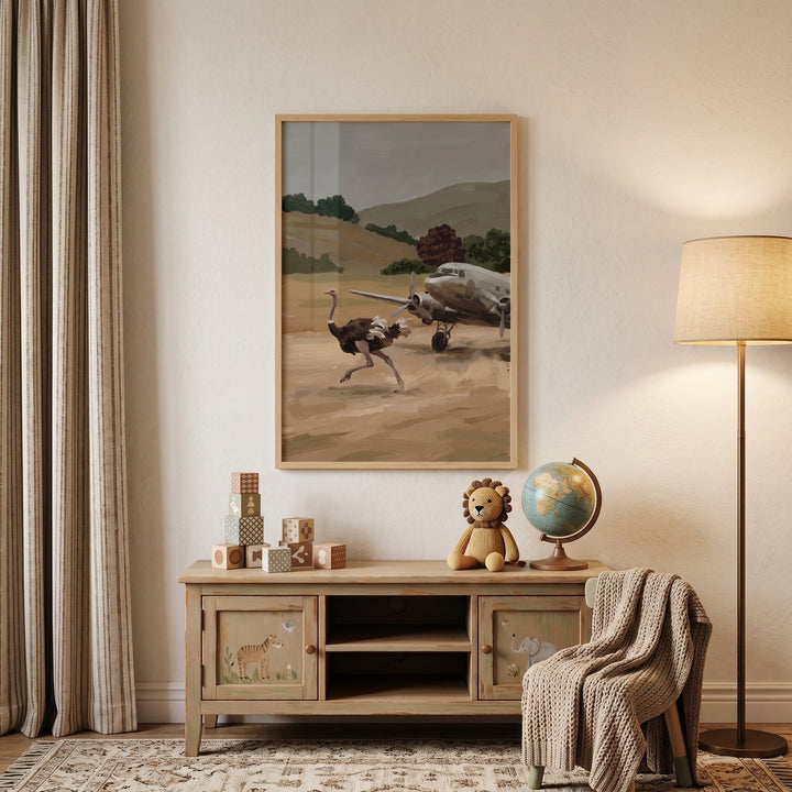 A cozy room with running desert ostrich wall art above a wood cabinet decorated with a lion toy, globe, and floor lamp.