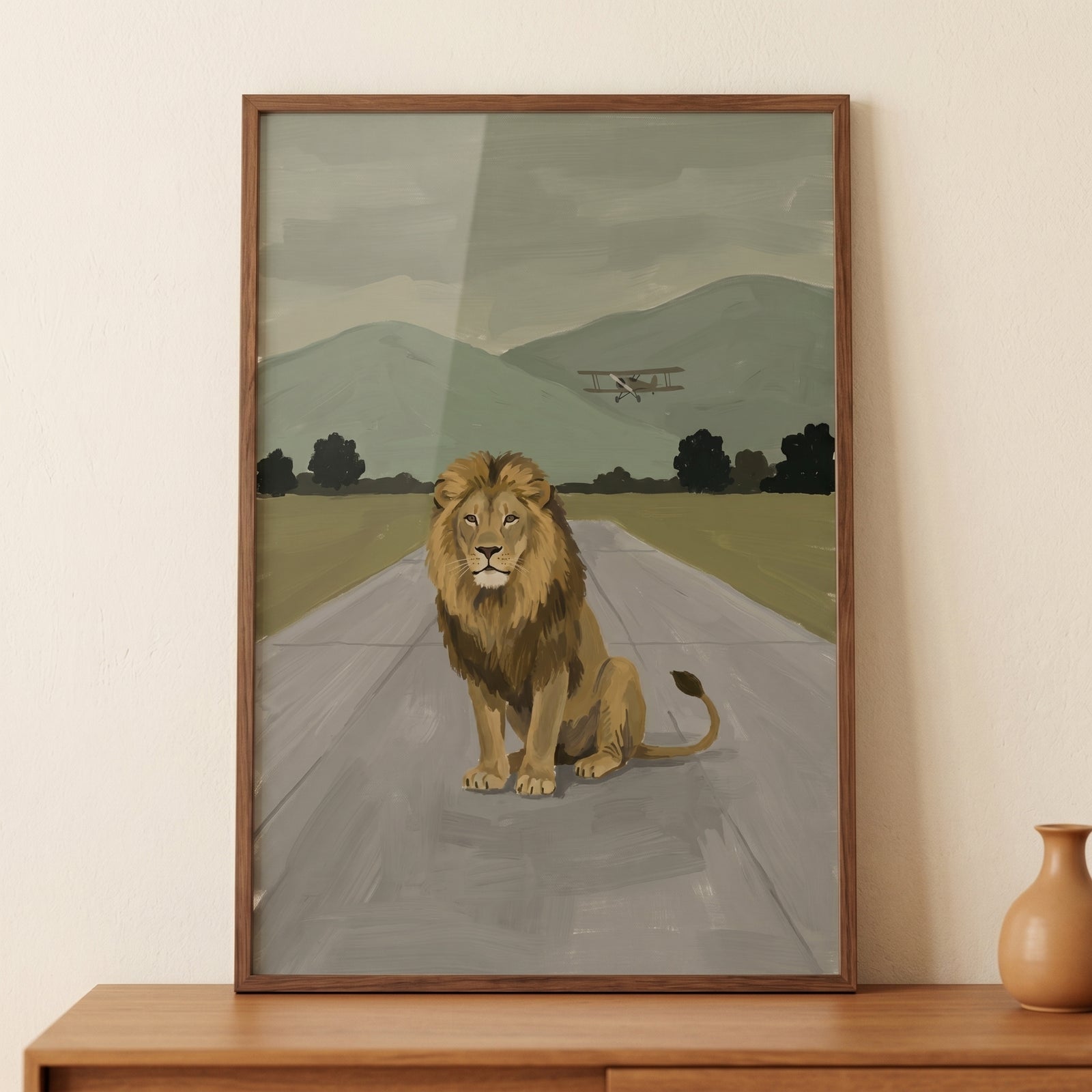 Runway biplane sitting lion wall art shows a lion on a landing strip with a small aircraft and distant mountains.