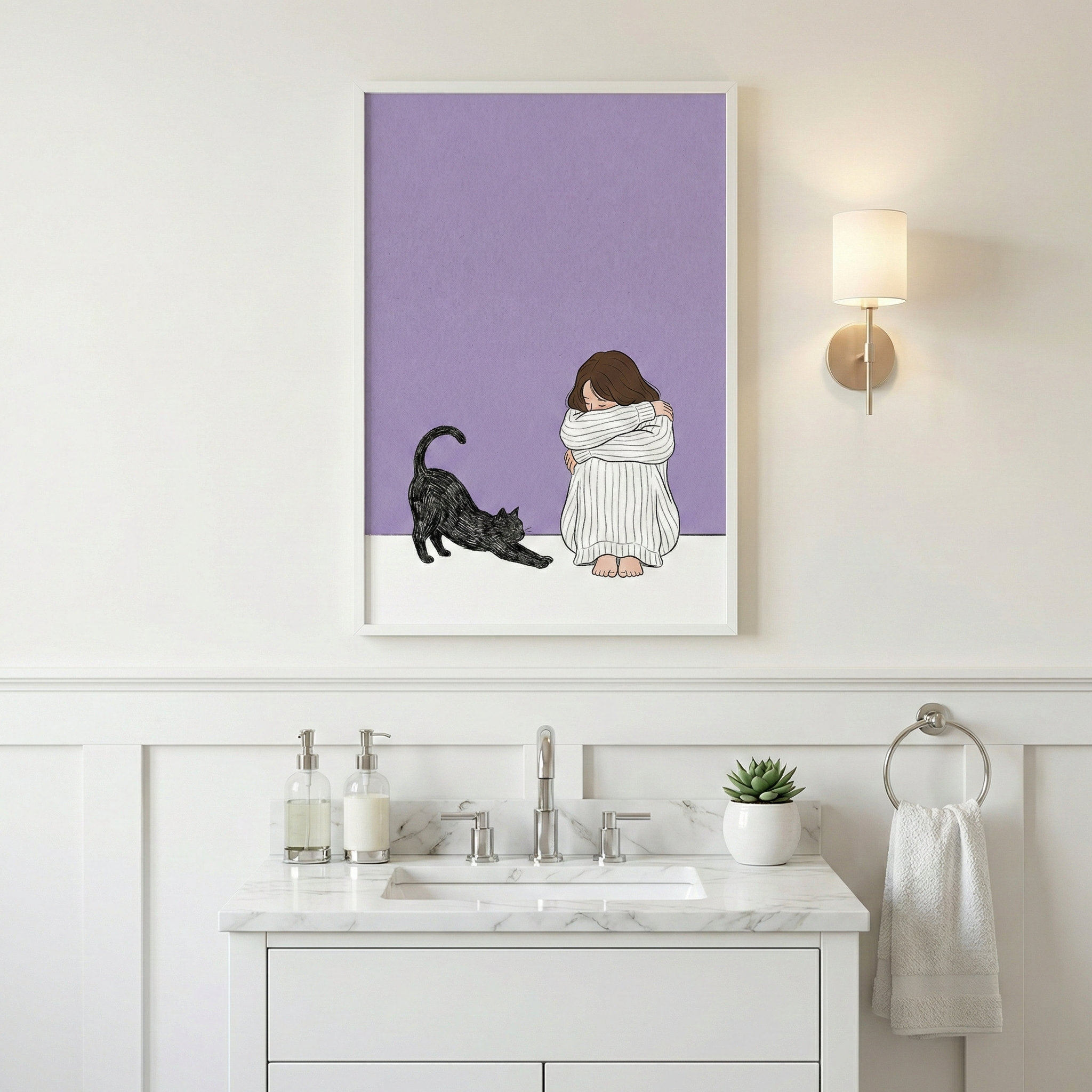 A framed vertical illustration hangs on a white paneled wall above a bathroom vanity. The artwork depicts a person in a white striped sweater sitting curled up next to a black cat stretching out. The background consists of solid lavender and white blocks. The white marble vanity below features a silver faucet, soap dispensers, and a small succulent. To the right, a minimalist wall lamp with a cylindrical shade glows, and a white hand towel hangs from a circular silver holder.