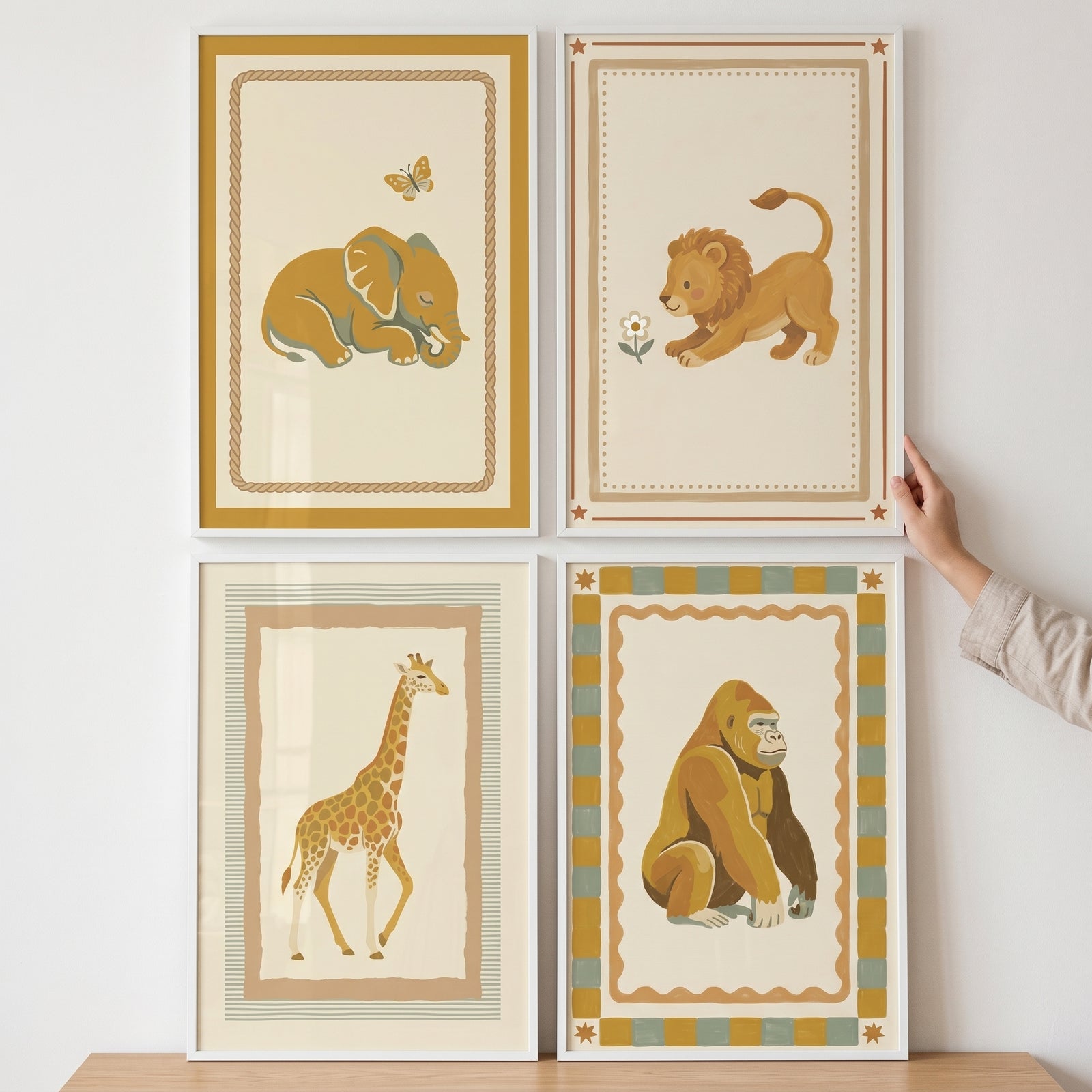 Safari animal wall art set of 4 featuring illustrations of an elephant, lion, giraffe, and gorilla in white frames.